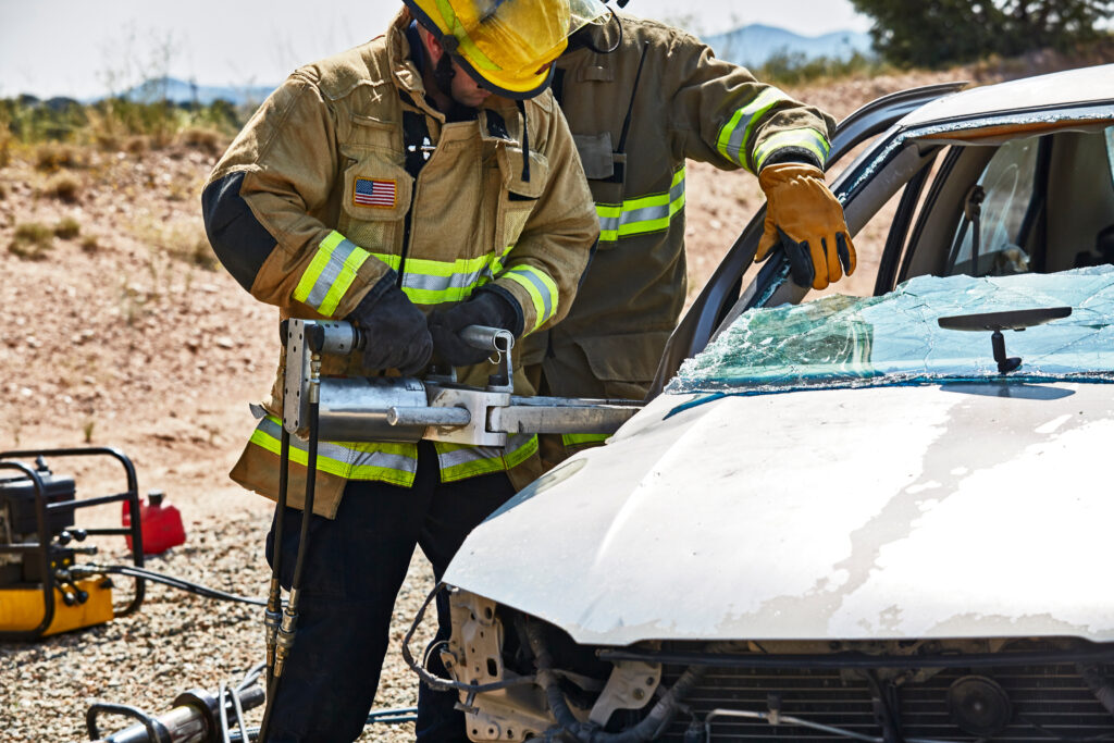 Paramedic Training class students learning rescue techniques using the Jaws of Life on a wrecked car