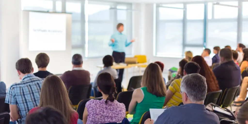 Speaker giving a lecture to a group of people

