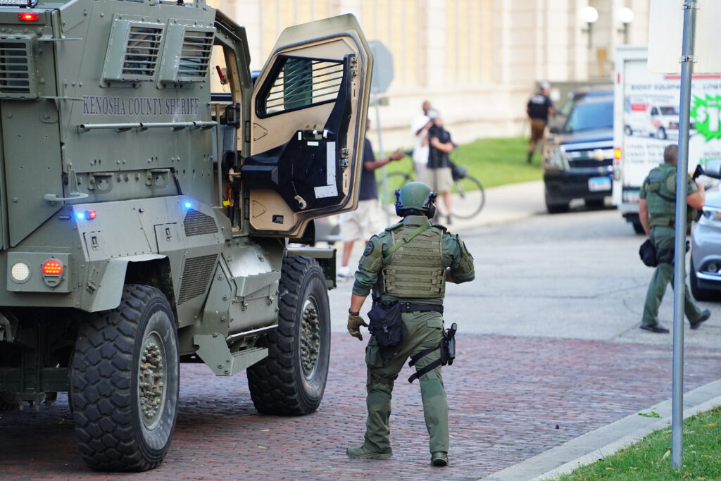 Kenosha county sheriff police officers in riot gear doing patrols in a Bearcat